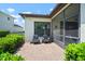 Cozy patio with brick pavers, seating, and lush greenery, perfect for outdoor relaxation and entertaining at 6307 Salt Creek Ave, Apollo Beach, FL 33572