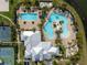 Overhead view of pools and a modern clubhouse, surrounded by palm trees at 6307 Salt Creek Ave, Apollo Beach, FL 33572