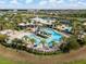 Aerial view of the community pool with slides, sun loungers, and palm trees at 6307 Salt Creek Ave, Apollo Beach, FL 33572