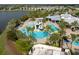 Aerial view of a community pool with slides, sun loungers, and tropical landscaping at 6307 Salt Creek Ave, Apollo Beach, FL 33572