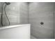 This luxurious shower features grey tile, a rain shower head, and built-in bench at 6307 Salt Creek Ave, Apollo Beach, FL 33572