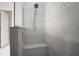 A shower featuring grey tile, a rain shower head, and built-in niche at 6307 Salt Creek Ave, Apollo Beach, FL 33572