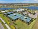 Aerial view of a community featuring tennis courts, pool and landscaping at 6307 Salt Creek Ave, Apollo Beach, FL 33572