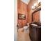 Elegant half bathroom with a patterned wall and beautiful vanity at 6408 Bright Bay Ct, Apollo Beach, FL 33572