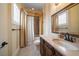 Well-lit bathroom with a curtained shower, window with shutters, and a marble sink at 6408 Bright Bay Ct, Apollo Beach, FL 33572