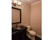 Chic powder room with decorative sink, dark vanity, and modern fixtures at 6408 Bright Bay Ct, Apollo Beach, FL 33572