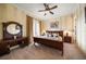 This spacious bedroom features striped walls, a ceiling fan, and a private balcony entrance at 6408 Bright Bay Ct, Apollo Beach, FL 33572