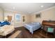 Bright bedroom featuring a queen bed, hardwood floors, and a private exit to the exterior at 6408 Bright Bay Ct, Apollo Beach, FL 33572