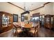Dining room featuring wood table, hardwood floors, bar area, and elegant display case at 6408 Bright Bay Ct, Apollo Beach, FL 33572