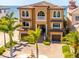 Stunning two-story Mediterranean home with a tile roof, arched windows, and meticulously manicured landscaping at 6408 Bright Bay Ct, Apollo Beach, FL 33572