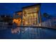 Stunning waterfront home boasts floor-to-ceiling windows overlooking a private pool and outdoor living space at 6408 Bright Bay Ct, Apollo Beach, FL 33572