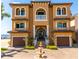 Beautiful two-story home with lush landscaping, a fountain, and a brick driveway and a two-car garage at 6408 Bright Bay Ct, Apollo Beach, FL 33572