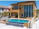 Large two-story home exterior with pool, spa, and waterfront view at 6408 Bright Bay Ct, Apollo Beach, FL 33572