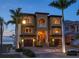 Charming two-story waterfront home with a two-car garage and a beautifully landscaped front yard at 6408 Bright Bay Ct, Apollo Beach, FL 33572