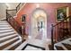 Elegant foyer with beautiful staircase, arched doorway and marble floors at 6408 Bright Bay Ct, Apollo Beach, FL 33572