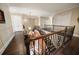 This hallway features hardwood floors, wrought iron railings, multiple entry doors and chandelier lighting at 6408 Bright Bay Ct, Apollo Beach, FL 33572