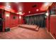 This home theater features tiered seating and a projector screen with blackout curtains at 6408 Bright Bay Ct, Apollo Beach, FL 33572