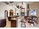 Open-concept kitchen and dining area with granite countertops, a breakfast bar, and high ceilings at 6408 Bright Bay Ct, Apollo Beach, FL 33572