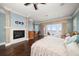 Spacious main bedroom with hardwood floors, fireplace, and balcony access at 6408 Bright Bay Ct, Apollo Beach, FL 33572