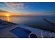 Beautiful infinity pool and spa offers serene water views at sunset at 6408 Bright Bay Ct, Apollo Beach, FL 33572