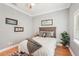 Comfortable bedroom featuring hardwood floors, ceiling fan, and a cozy queen-sized bed at 6461 Rubia Cir, Apollo Beach, FL 33572