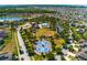 Aerial view of community amenities including a pool, clubhouse, tennis courts, and lush green spaces at 6534 Trent Creek Dr, Ruskin, FL 33573