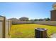 Large grassy backyard enclosed by a white fence, showcasing ample outdoor space at 6534 Trent Creek Dr, Ruskin, FL 33573