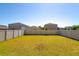 Large backyard featuring a green lawn and white vinyl fencing, offering privacy at 6534 Trent Creek Dr, Ruskin, FL 33573