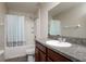 Bathroom featuring a shower with blue and gray shower curtain, granite countertop, and white sink at 6534 Trent Creek Dr, Ruskin, FL 33573