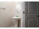 Powder room features a pedestal sink, modern fixtures, and a neutral color scheme at 6534 Trent Creek Dr, Ruskin, FL 33573