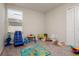 Bright bedroom with window and a variety of colorful toys spread across the floor at 6534 Trent Creek Dr, Ruskin, FL 33573
