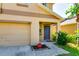 Close-up of home's front entrance and two-car garage with manicured shrubbery at 6534 Trent Creek Dr, Ruskin, FL 33573