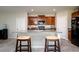 Kitchen with an island, dark wood cabinets, stainless appliances and tile flooring at 6534 Trent Creek Dr, Ruskin, FL 33573
