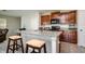 Kitchen features a center island with granite countertop, dark wood cabinets, and stainless appliances at 6534 Trent Creek Dr, Ruskin, FL 33573