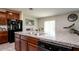 Open-concept kitchen with stainless steel sink, dishwasher and breakfast bar at 6534 Trent Creek Dr, Ruskin, FL 33573