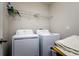 Functional laundry room with a modern washer and dryer, plus wire shelving for storage at 6534 Trent Creek Dr, Ruskin, FL 33573