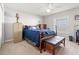 Bedroom featuring a ceiling fan, window and traditional-style furnishings at 6745 Basswood Cir, Zephyrhills, FL 33542