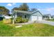 Charming single-story home with a well-maintained lawn and attached two-car garage at 6745 Basswood Cir, Zephyrhills, FL 33542