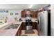 Functional kitchen with stainless steel appliances and hardwood floors at 6745 Basswood Cir, Zephyrhills, FL 33542