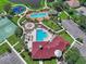 A beautiful aerial view showing the community pool, splash pad, basketball court, playground, and clubhouse at 7413 Surrey Wood Ln, Apollo Beach, FL 33572