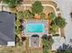 Aerial view of pool with sundeck, lounge chairs, and nearby parking at 7413 Surrey Wood Ln, Apollo Beach, FL 33572