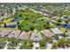 Residential neighborhood aerial shot with pond, trees, and lawns at 7413 Surrey Wood Ln, Apollo Beach, FL 33572