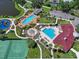 A high angle view of the community amenities, including the swimming pool, playground, splash pad, and sports courts at 7413 Surrey Wood Ln, Apollo Beach, FL 33572