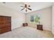 The spacious bedroom includes a ceiling fan and large window for natural light at 7413 Surrey Wood Ln, Apollo Beach, FL 33572