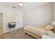 Neutral bedroom features a bed, a ceiling fan and a TV on a side table at 7413 Surrey Wood Ln, Apollo Beach, FL 33572
