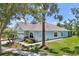 Beautiful single-story home with stone accents, lush landscaping, and a well-manicured lawn on a sunny day at 7413 Surrey Wood Ln, Apollo Beach, FL 33572