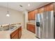 Kitchen with stainless steel refrigerator, tan countertops, and tile floors at 7413 Surrey Wood Ln, Apollo Beach, FL 33572