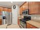 Kitchen offers stainless steel appliances, tile backsplash, and ample cabinet space at 7413 Surrey Wood Ln, Apollo Beach, FL 33572
