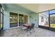 This screened patio features tile flooring and provides an ideal space for relaxation and outdoor dining at 7413 Surrey Wood Ln, Apollo Beach, FL 33572
