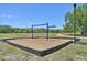 Community playground featuring swings, wooden chips, and shaded seating at 7413 Surrey Wood Ln, Apollo Beach, FL 33572